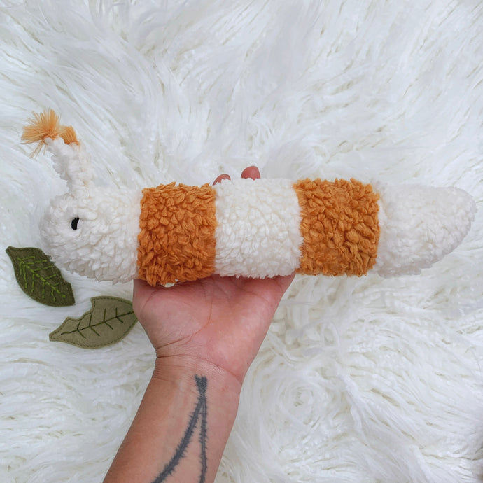 Creamsicle puff caterpillar with two leaves